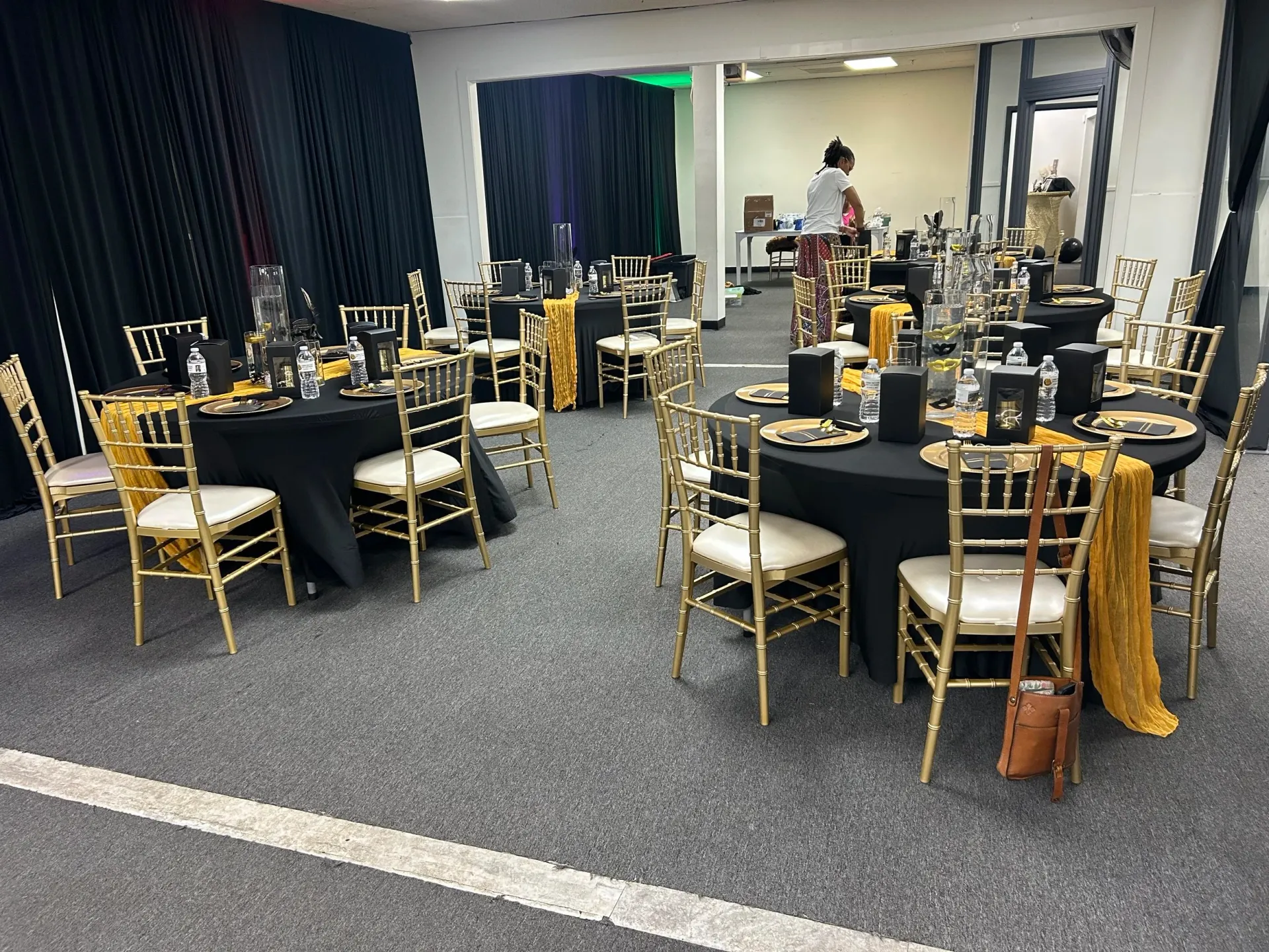 The A&C hall set with gold Chiavari chairs and black linens